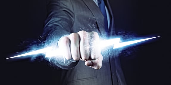 Businessman holding lightning in fist. Power and control